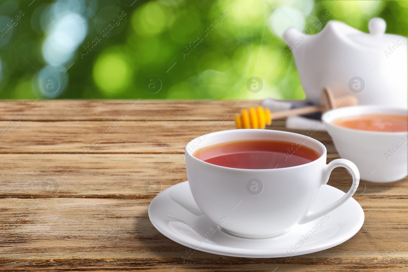 Cup of hot freshly brewed rooibos tea on wooden table outdoors Image of Cup of hot freshly brewed rooibos tea on wooden table outdoors