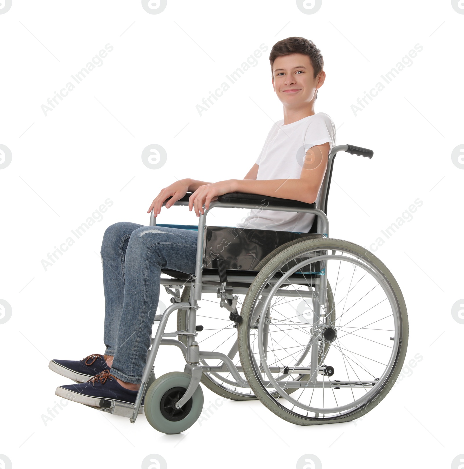 Teen boy in wheelchair on white background Photo of Teen boy in wheelchair on white background