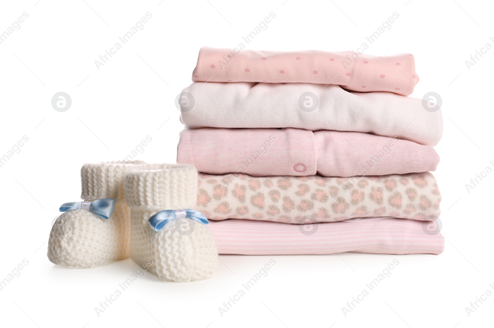 Stack of baby girl's clothes and booties on white background Photo of Stack of baby girl's clothes and booties on white background