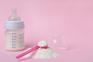 Powdered infant formula with scoop and feeding bottle on pink background, space for text. Baby milk Photo of Powdered infant formula with scoop and feeding bottle on pink background, space for text. Baby milk