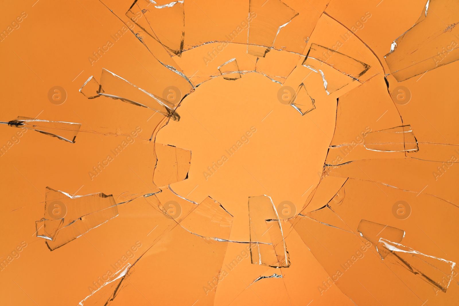 Broken glass with cracks on orange background Image of Broken glass with cracks on orange background