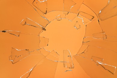 Broken glass with cracks on orange background Image of Broken glass with cracks on orange background