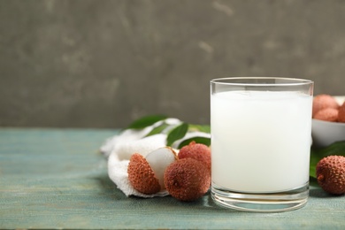 Fresh lychee juice and fruits on blue wooden table. Space for text Photo of Fresh lychee juice and fruits on blue wooden table. Space for text