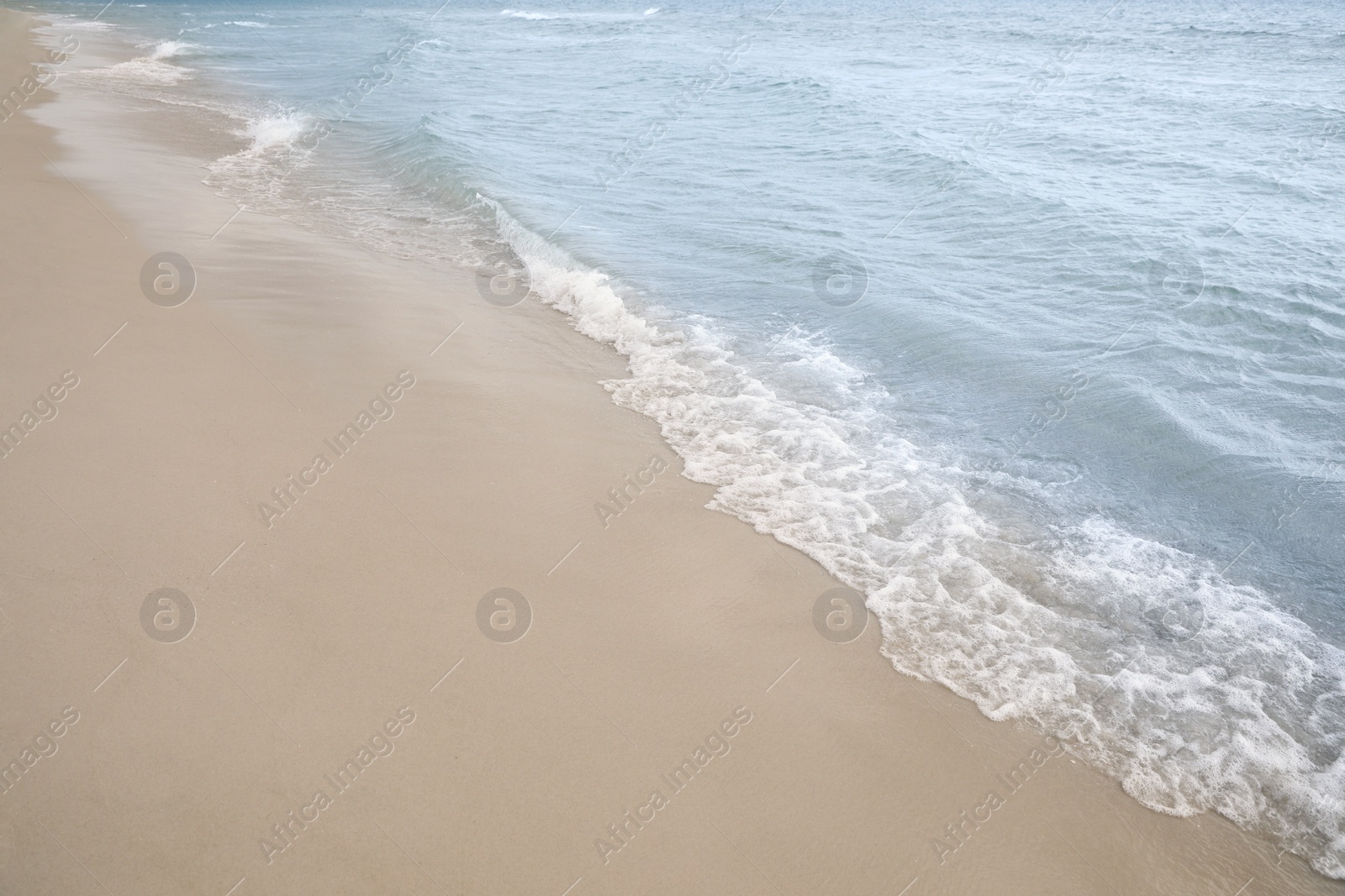 Sea waves rolling onto sandy tropical beach Photo of Sea waves rolling onto sandy tropical beach