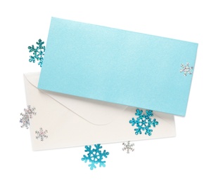 Blank Christmas card, envelope and snowflakes on white background, top view with space for text Photo of Blank Christmas card, envelope and snowflakes on white background, top view with space for text