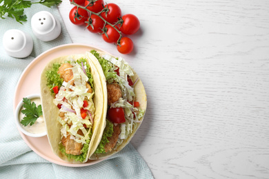 Yummy fish tacos served on white wooden table, flat lay. Space for text Photo of Yummy fish tacos served on white wooden table, flat lay. Space for text