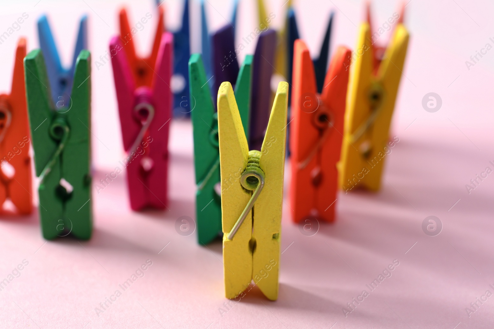 Many different colorful clothes pins on pink background. Diversity concept Photo of Many different colorful clothes pins on pink background. Diversity concept