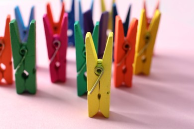 Many different colorful clothes pins on pink background. Diversity concept Photo of Many different colorful clothes pins on pink background. Diversity concept