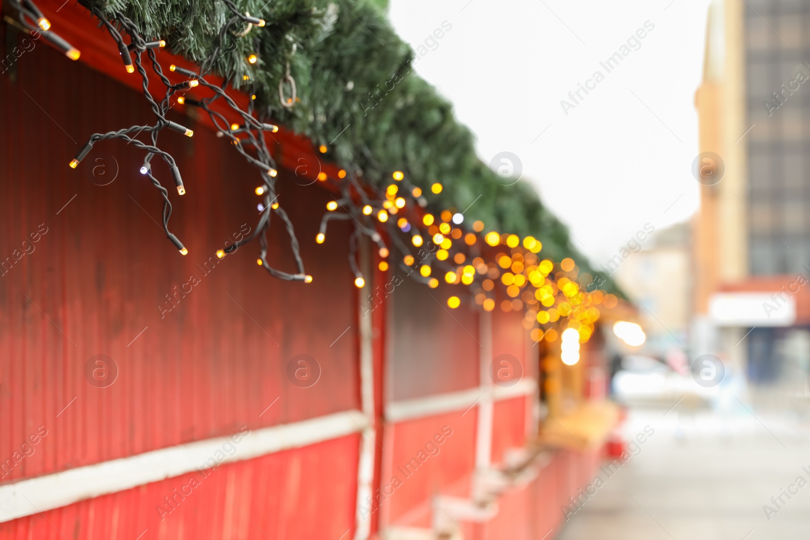 Christmas fair stall with string lights outdoors Photo of Christmas fair stall with string lights outdoors