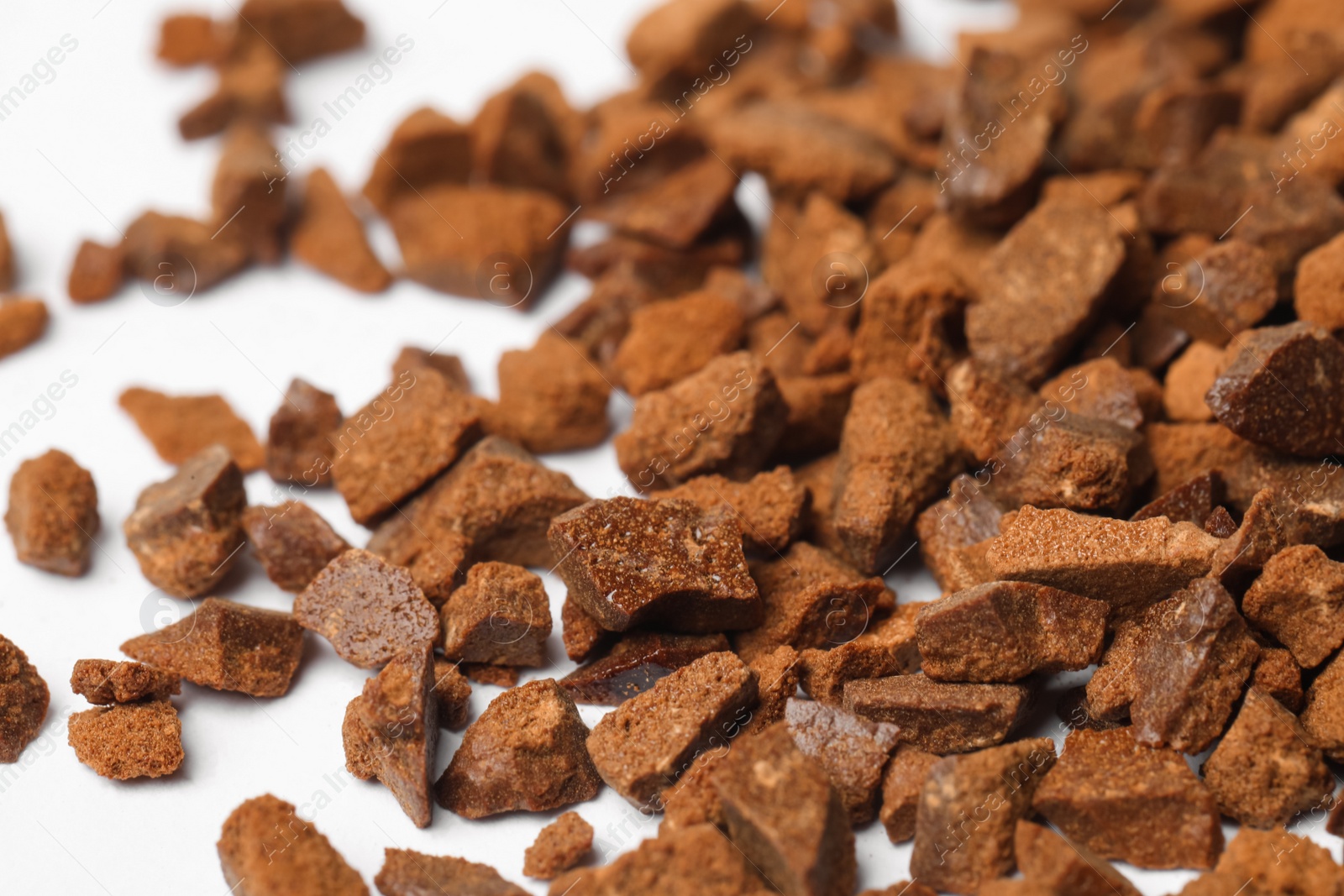 Pile of chicory granules on white background, closeup Photo of Pile of chicory granules on white background, closeup
