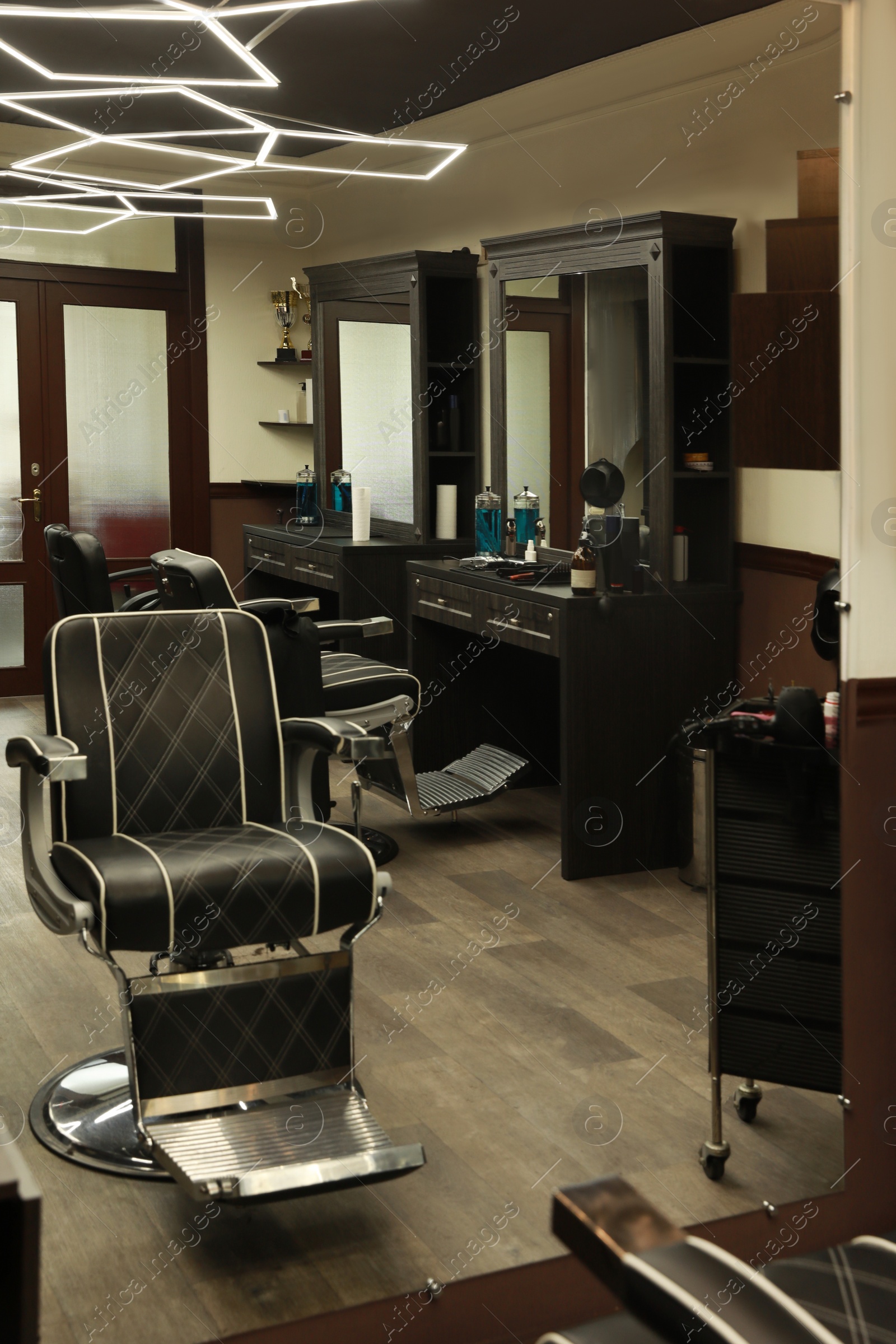 Stylish hairdresser's workplace with professional armchair in barbershop Photo of Stylish hairdresser's workplace with professional armchair in barbershop
