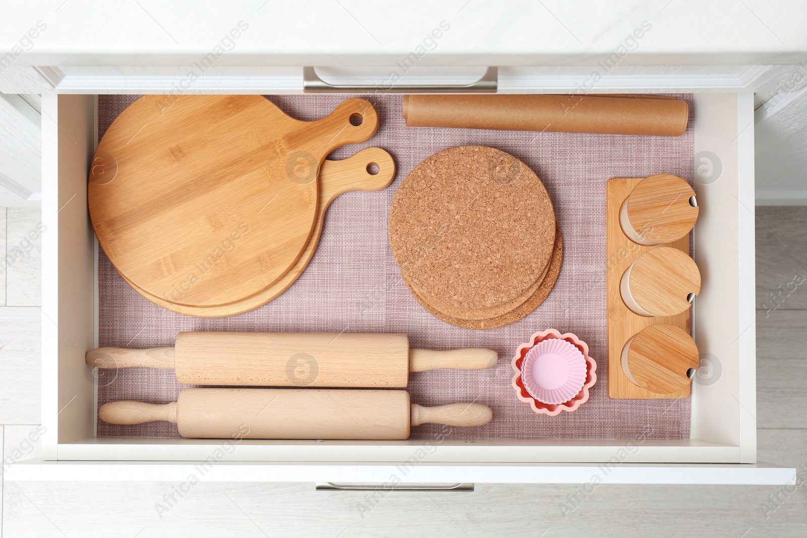 Open drawer with wooden utensils indoors. Order in kitchen Photo of Open drawer with wooden utensils indoors. Order in kitchen