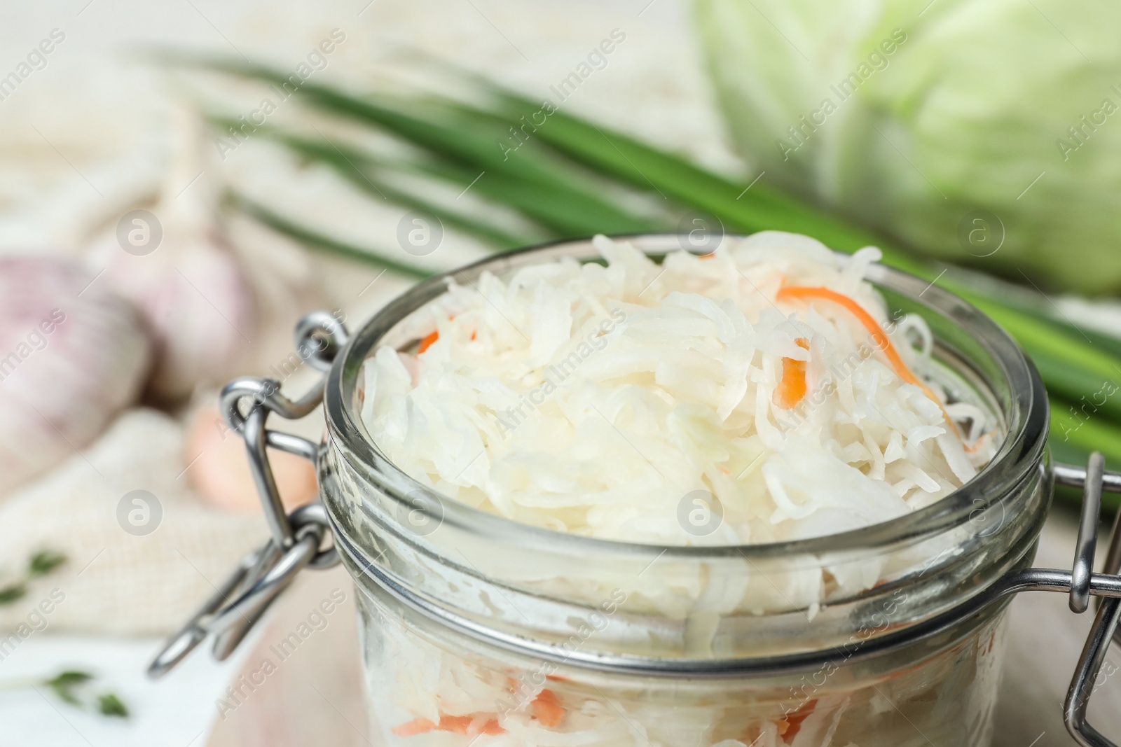Jar of tasty fermented cabbage on table, closeup Photo of Jar of tasty fermented cabbage on table, closeup