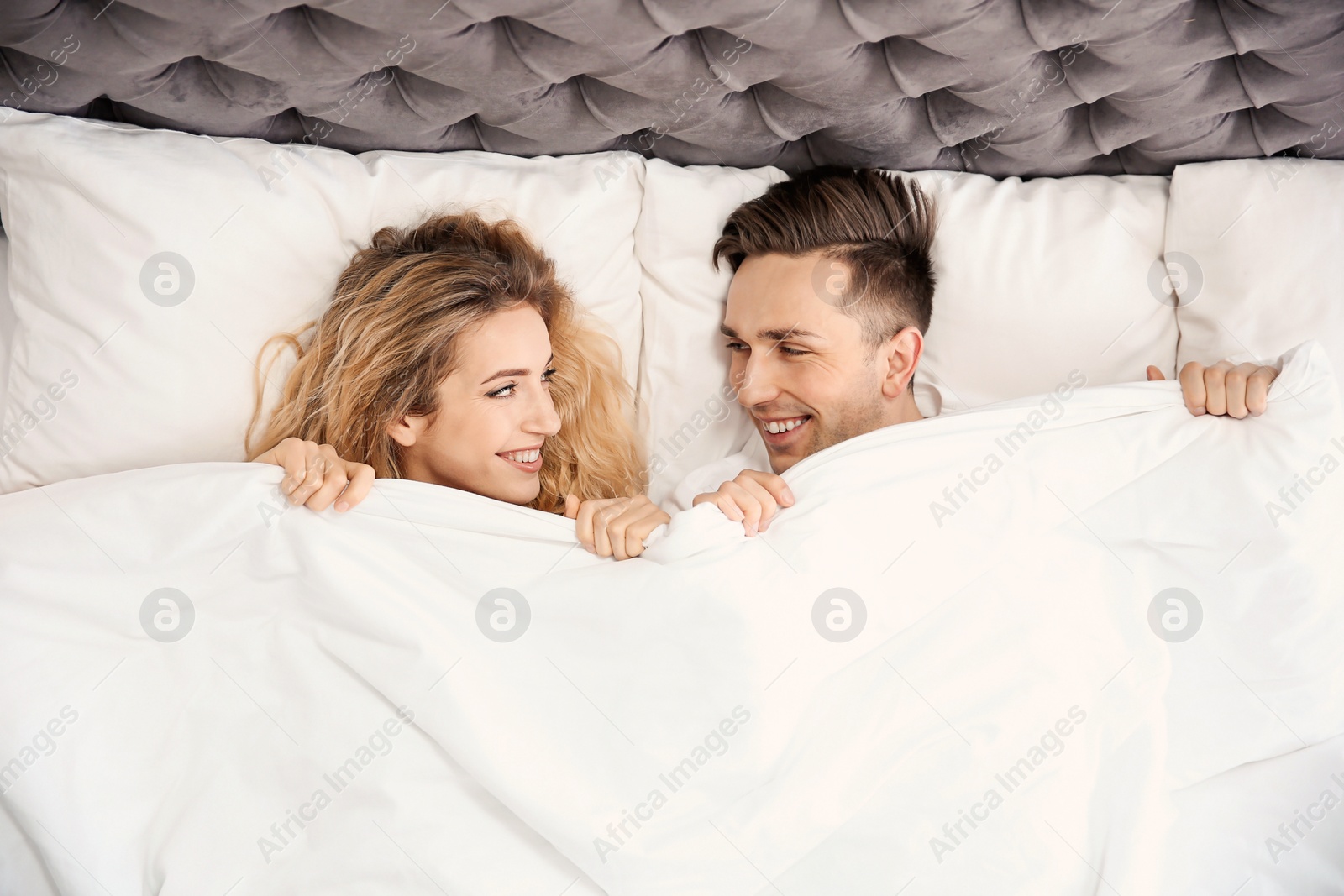 Lovely young couple lying in bed at home Photo of Lovely young couple lying in bed at home
