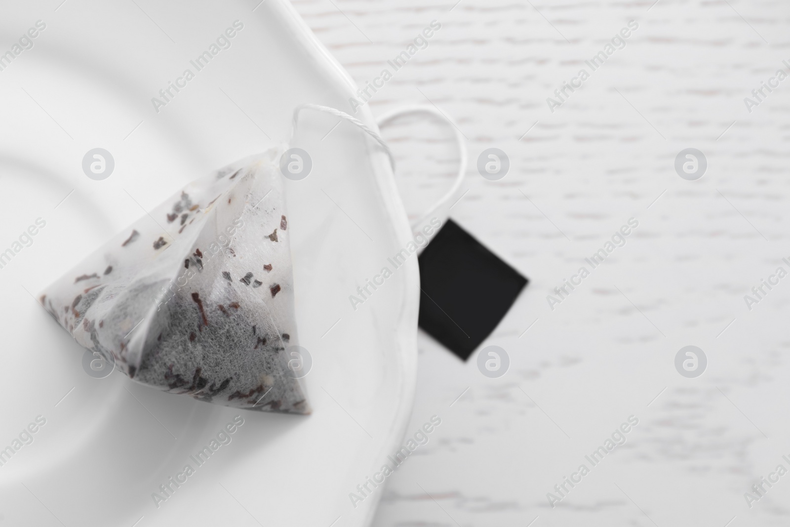 Pyramid tea bag on white table, top view. Space for text Photo of Pyramid tea bag on white table, top view. Space for text