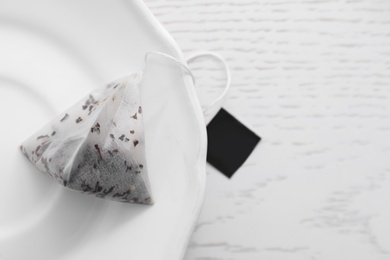 Pyramid tea bag on white table, top view. Space for text Photo of Pyramid tea bag on white table, top view. Space for text