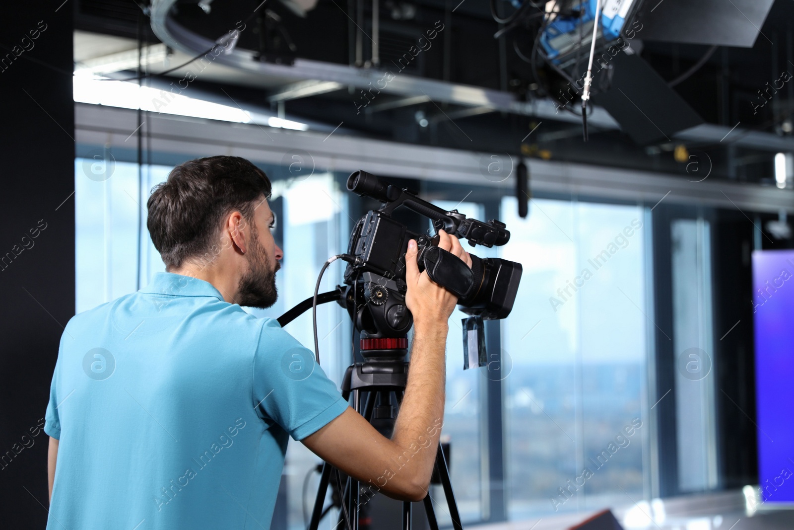 Professional video camera operator working in studio Photo of Professional video camera operator working in studio