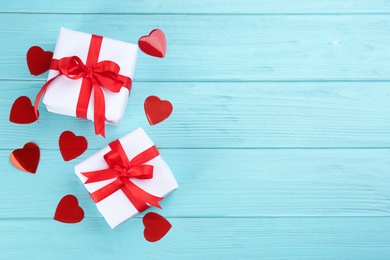Gift boxes and hearts on turquoise wooden background, flat lay with space for text. Valentine's Day celebration Photo of Gift boxes and hearts on turquoise wooden background, flat lay with space for text. Valentine's Day celebration
