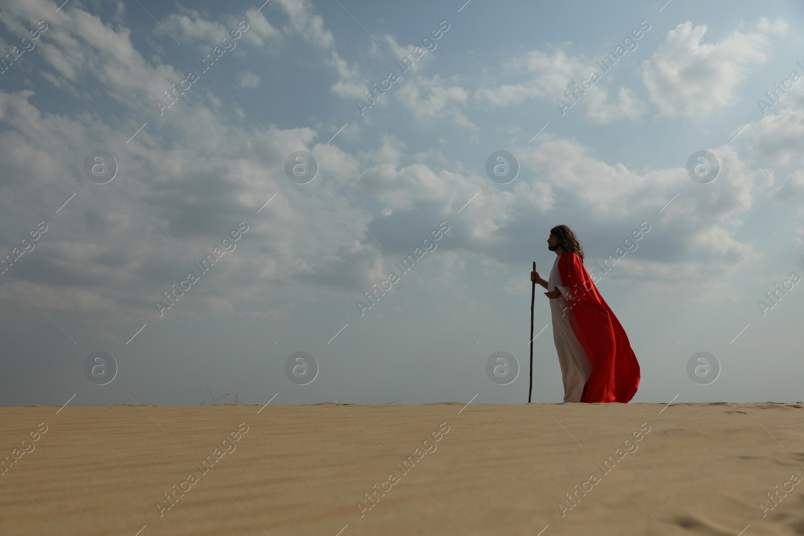 Jesus Christ walking with stick in desert. Space for text Photo of Jesus Christ walking with stick in desert. Space for text