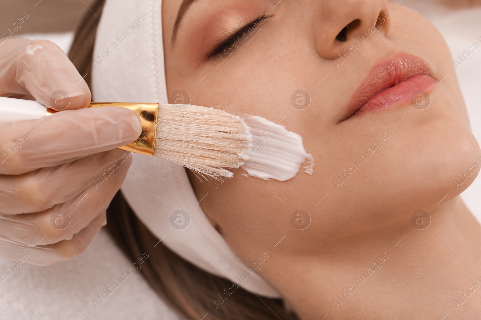 Young woman during face peeling procedure in salon, closeup Photo of Young woman during face peeling procedure in salon, closeup