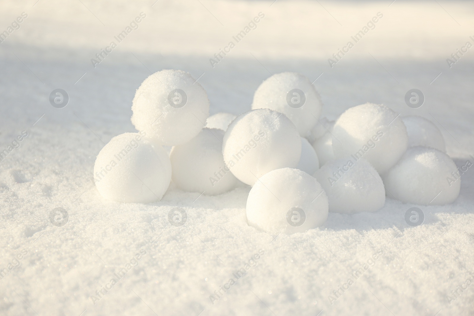 Pile of perfect round snowballs on snow outdoors Photo of Pile of perfect round snowballs on snow outdoors