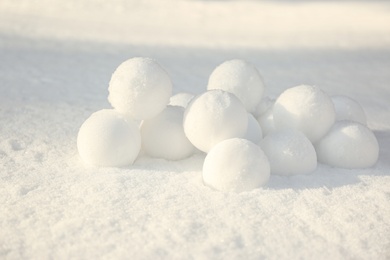 Pile of perfect round snowballs on snow outdoors Photo of Pile of perfect round snowballs on snow outdoors