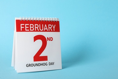 Calendar with date February 2nd on light blue background, space for text. Groundhog day Photo of Calendar with date February 2nd on light blue background, space for text. Groundhog day