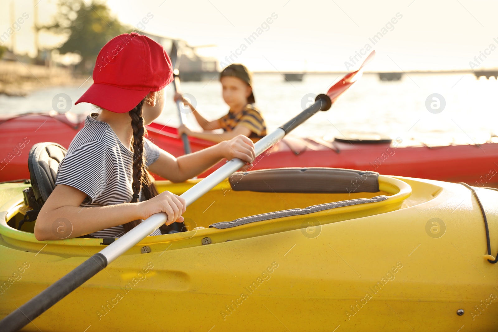 Little children kayaking on river. Summer camp activity Photo of Little children kayaking on river. Summer camp activity