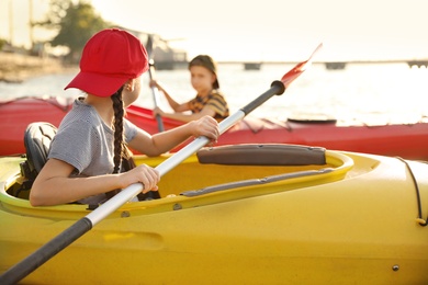 Little children kayaking on river. Summer camp activity Photo of Little children kayaking on river. Summer camp activity