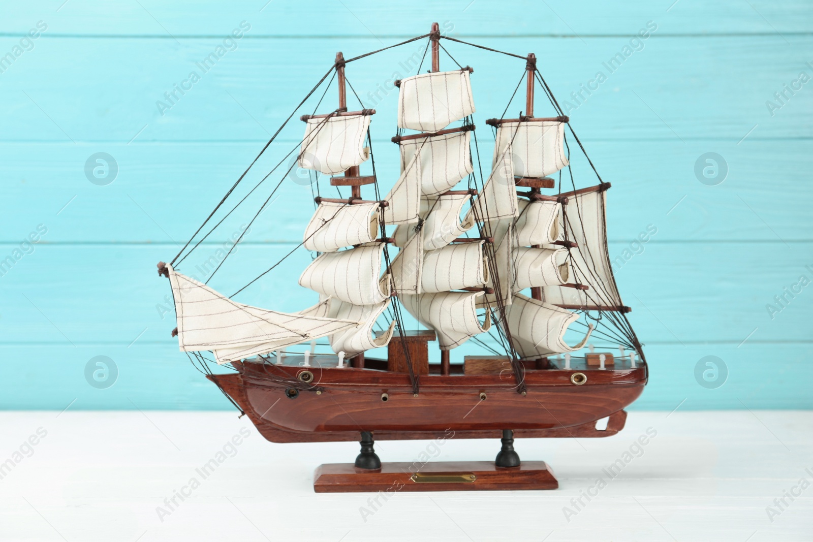 Beautiful ship model on white wooden table Photo of Beautiful ship model on white wooden table