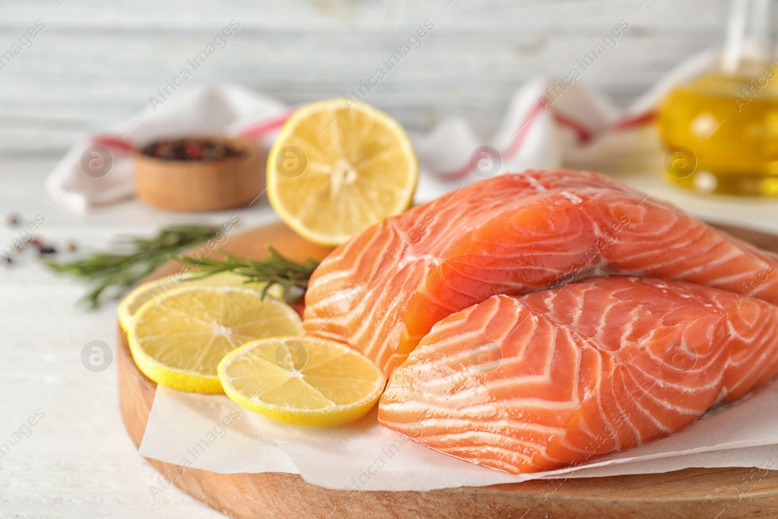 Fresh raw salmon with lemon on table. Fish delicacy Photo of Fresh raw salmon with lemon on table. Fish delicacy