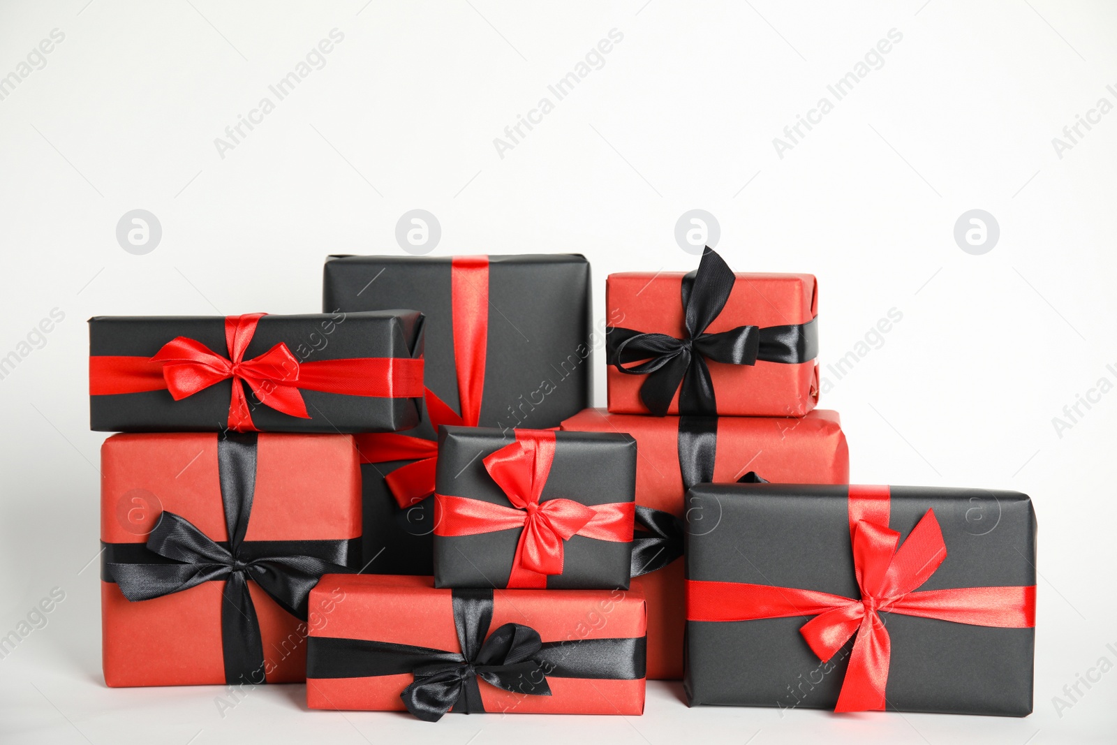 Photo of Many gift boxes on white background. Black Friday