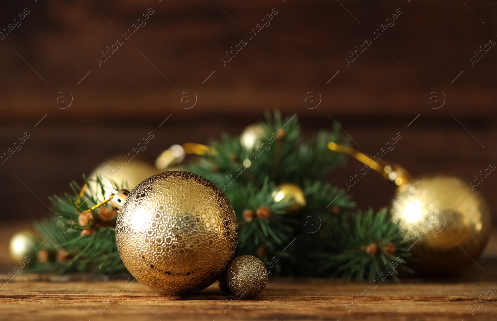 Beautiful Christmas balls and fir branch on wooden table. Space for text Photo of Beautiful Christmas balls and fir branch on wooden table. Space for text