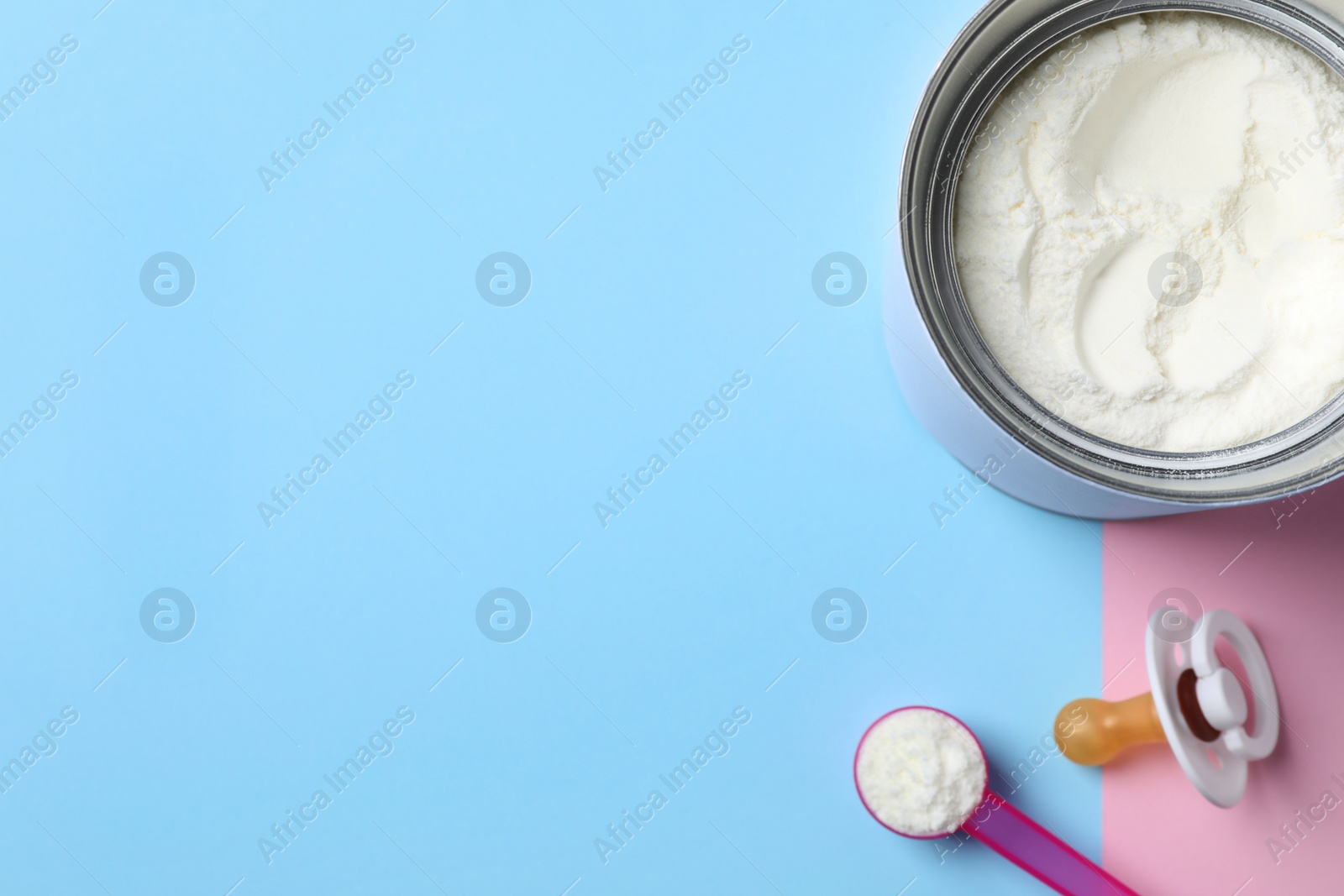 Flat lay composition with powdered infant formula on color background, space for text. Baby milk Photo of Flat lay composition with powdered infant formula on color background, space for text. Baby milk