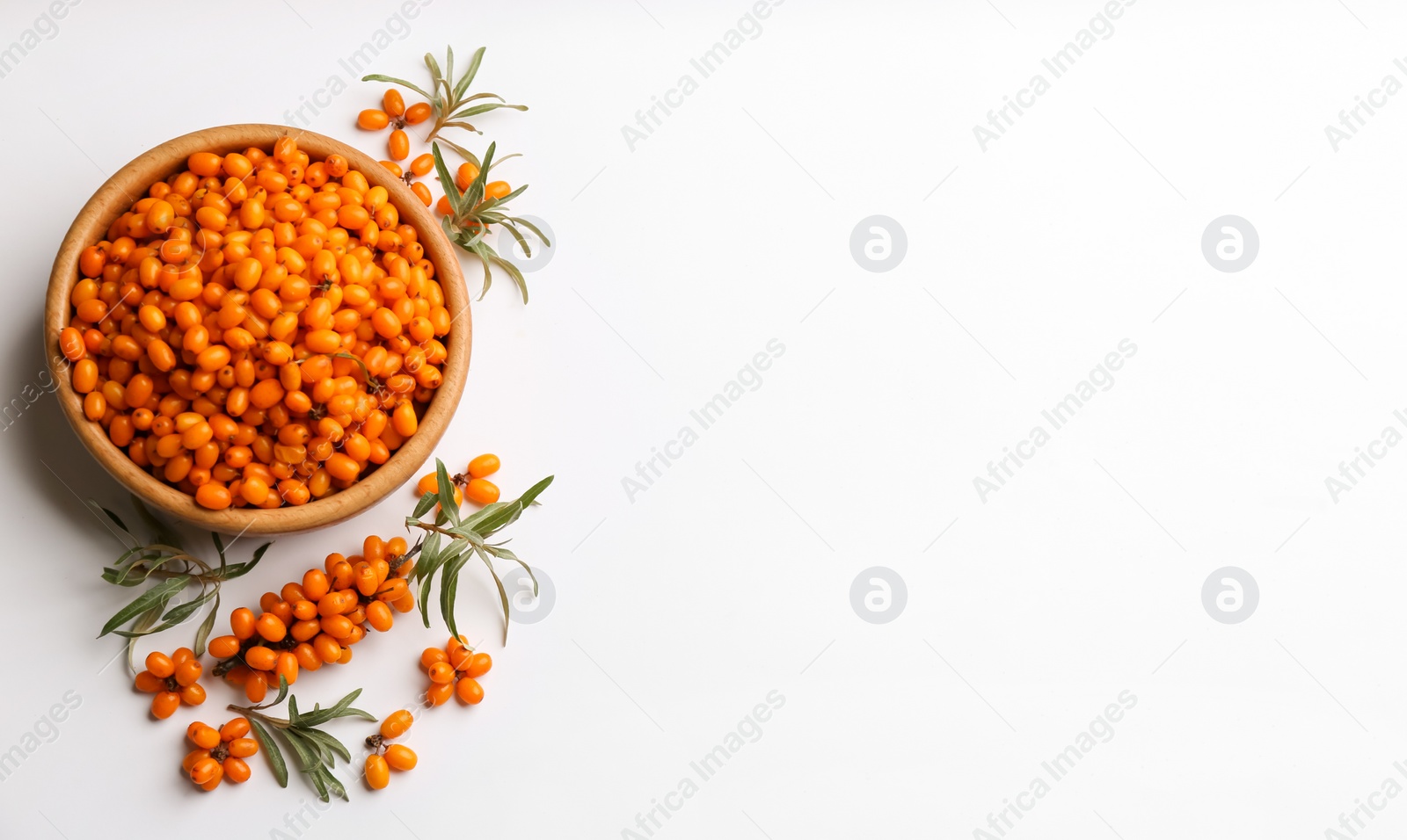 Fresh ripe sea buckthorn on white background, flat lay. Space for text Photo of Fresh ripe sea buckthorn on white background, flat lay. Space for text