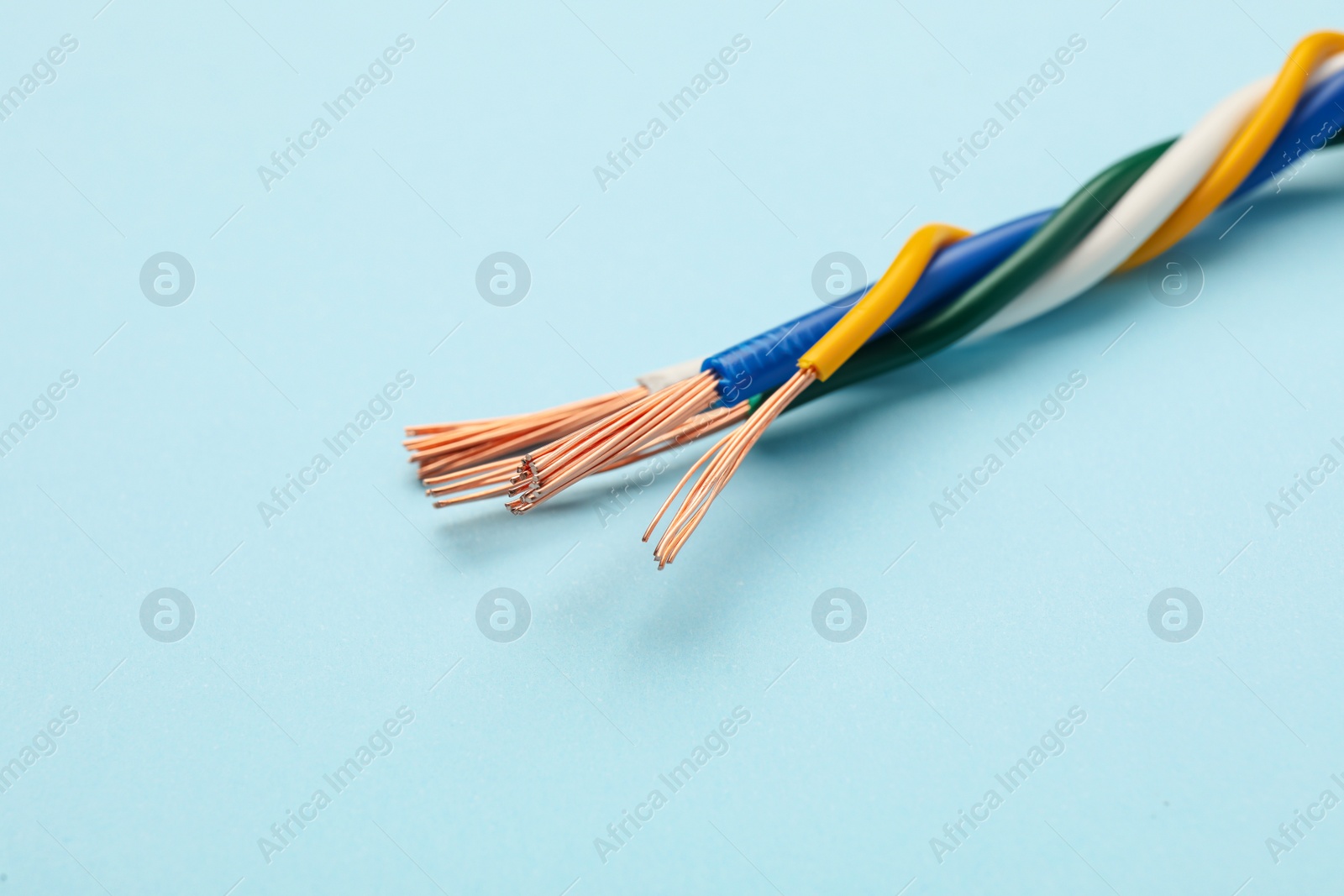 Many stripped electrical wires on light blue background, closeup Photo of Many stripped electrical wires on light blue background, closeup