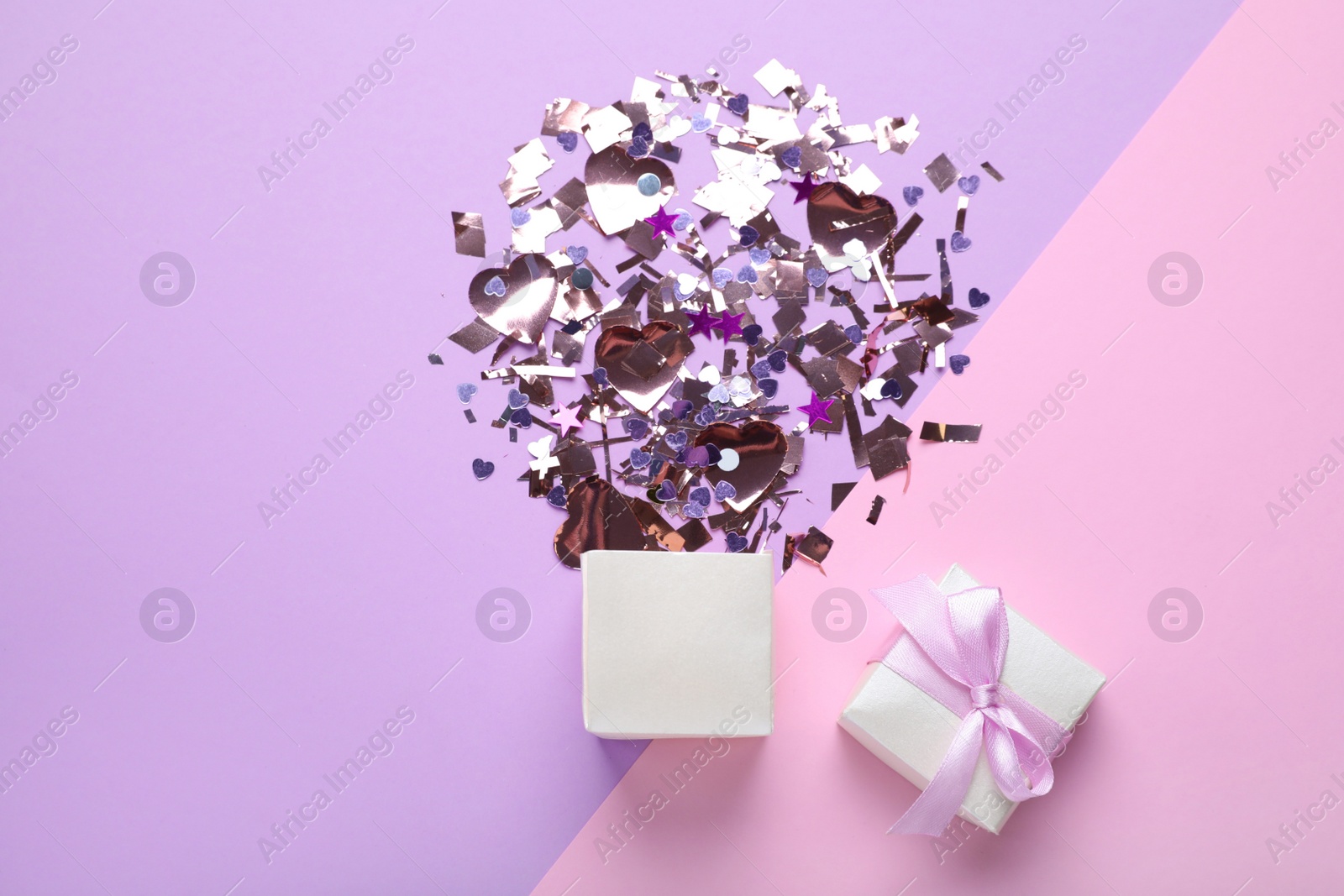 Flat lay composition with shiny confetti and box on color background Photo of Flat lay composition with shiny confetti and box on color background