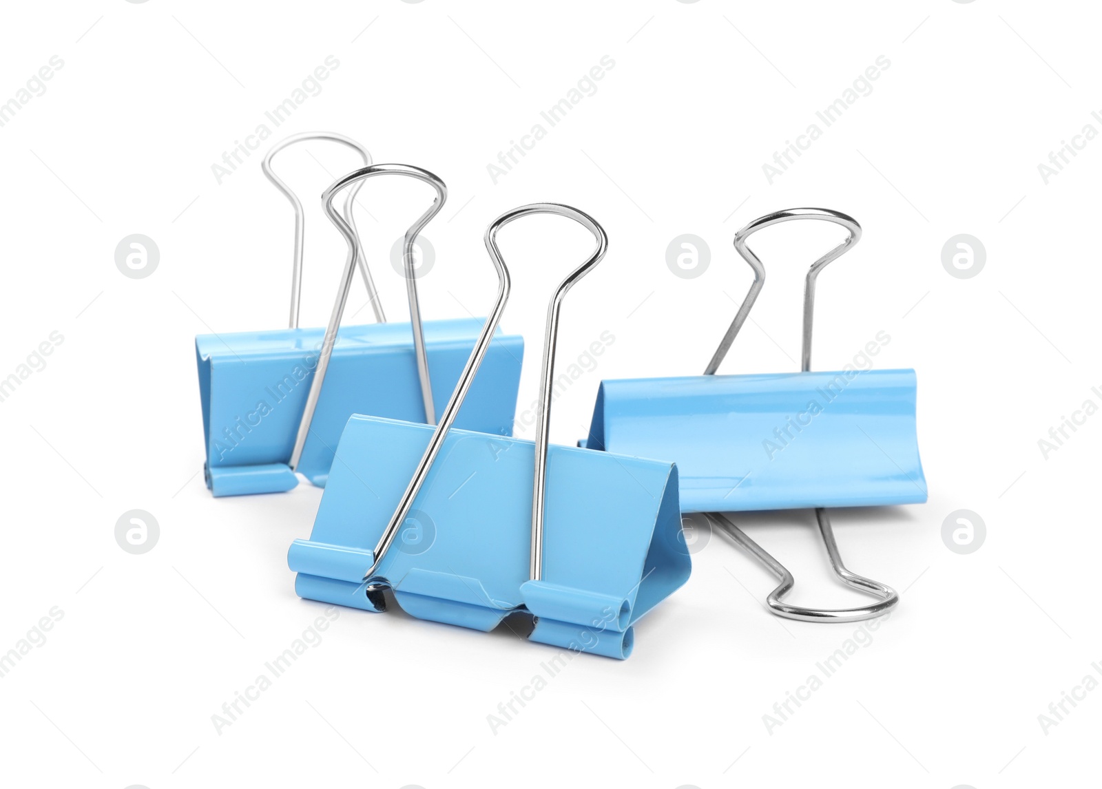 Light blue binder clips on white background. Stationery Photo of Light blue binder clips on white background. Stationery