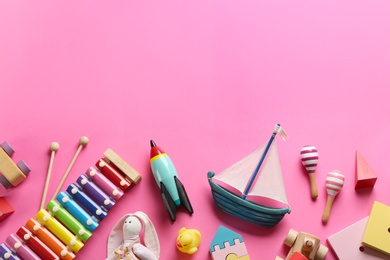 Flat lay composition with different toys on pink background. Space for text Photo of Flat lay composition with different toys on pink background. Space for text