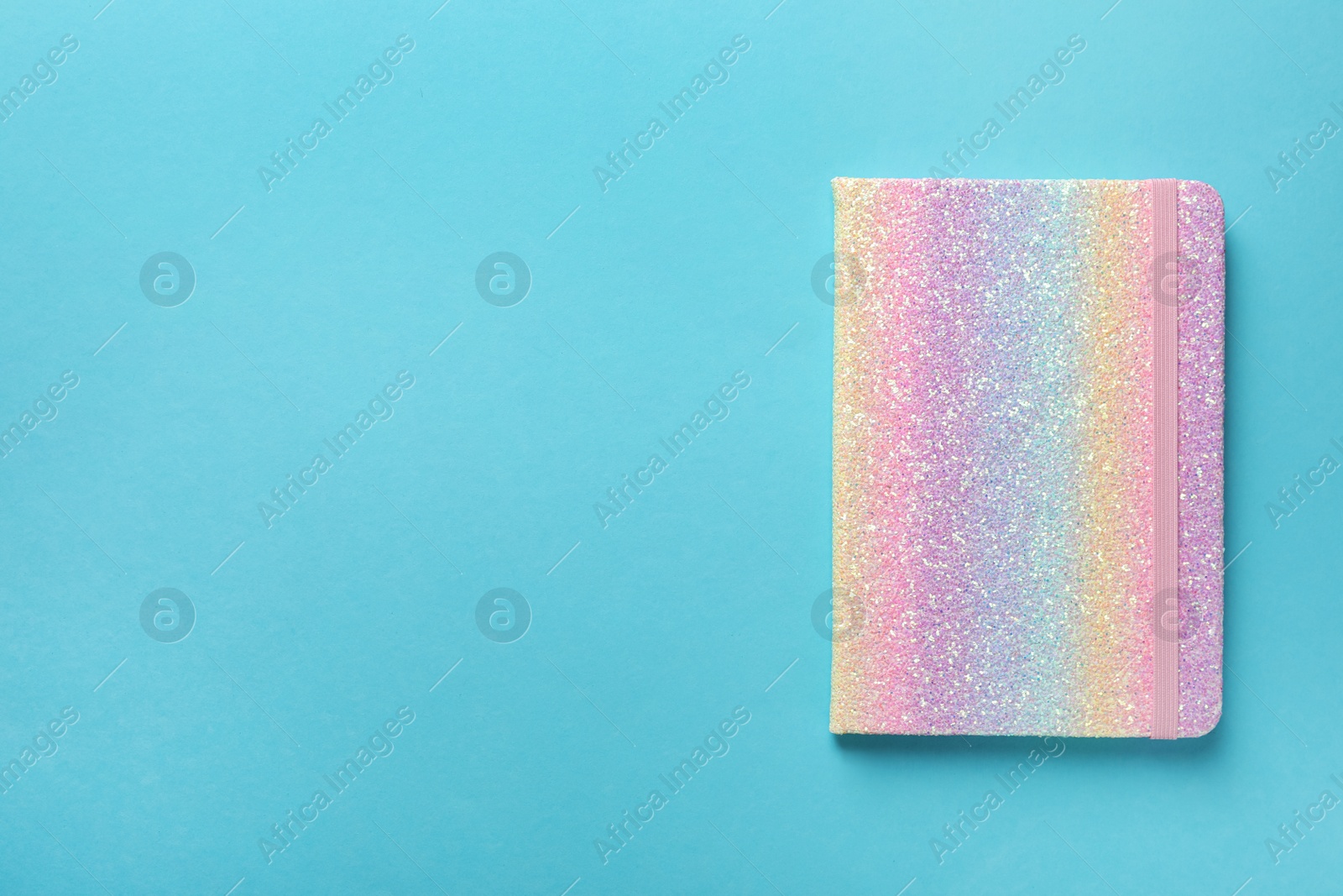 New stylish planner on light blue background, top view. Space for text Photo of New stylish planner on light blue background, top view. Space for text