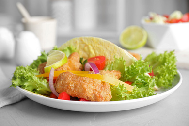 Delicious fish tacos served on light grey table, closeup Photo of Delicious fish tacos served on light grey table, closeup