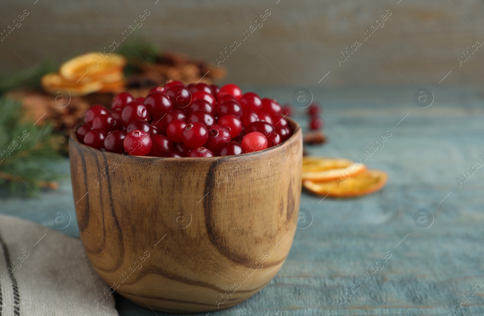 Fresh ripe cranberries on blue wooden table. Space for text Photo of Fresh ripe cranberries on blue wooden table. Space for text