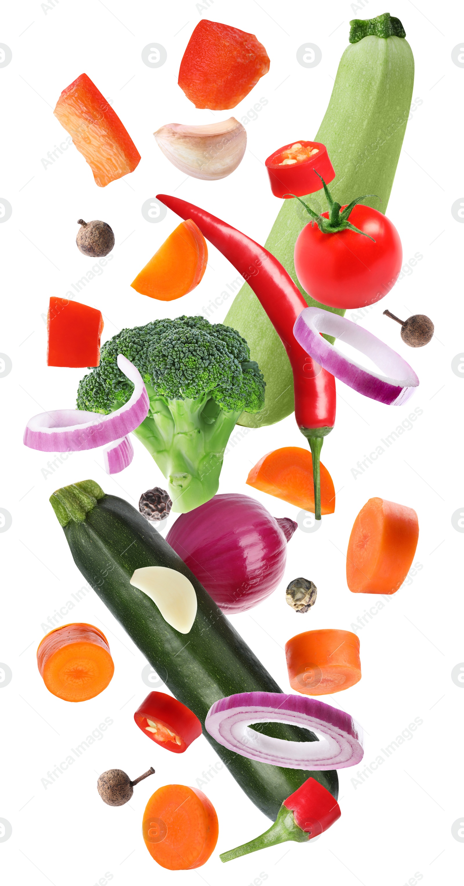 Set of different fresh vegetables and spices falling on white background Image of Set of different fresh vegetables and spices falling on white background