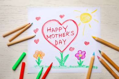 Flat lay composition with drawing for Mother's day on white wooden background Photo of Flat lay composition with drawing for Mother's day on white wooden background