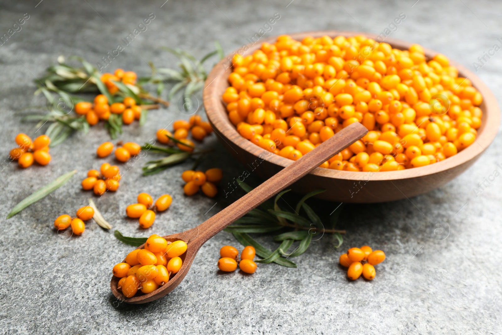Fresh ripe sea buckthorn on grey table Photo of Fresh ripe sea buckthorn on grey table
