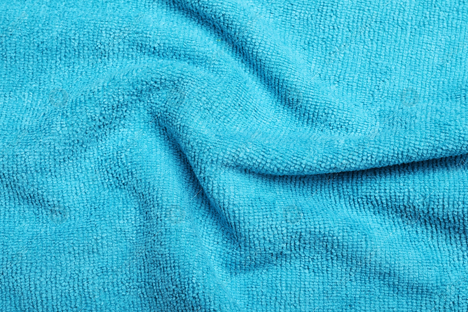 Crumpled light blue microfiber cloth as background, closeup Photo of Crumpled light blue microfiber cloth as background, closeup