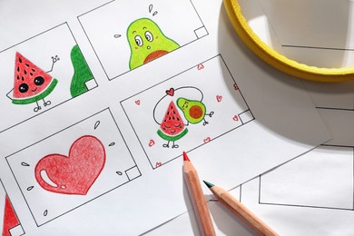 Storyboard with cartoon sketches at workplace, flat lay. Pre-production process Photo of Storyboard with cartoon sketches at workplace, flat lay. Pre-production process