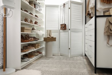 Dressing room interior with stylish shoes and accessories on shelves Photo of Dressing room interior with stylish shoes and accessories on shelves