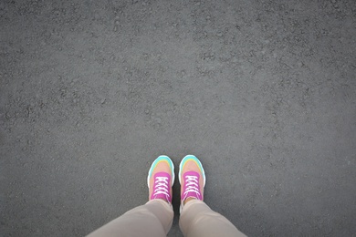 Woman standing outdoors, top view. Space for text Photo of Woman standing outdoors, top view. Space for text