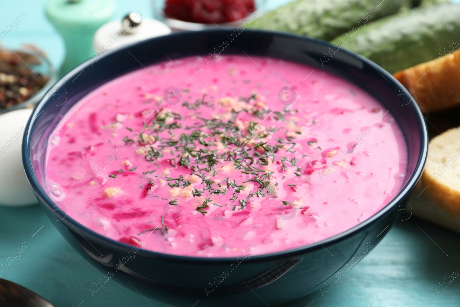 Delicious cold summer beet soup on light blue wooden table, closeup Photo of Delicious cold summer beet soup on light blue wooden table, closeup